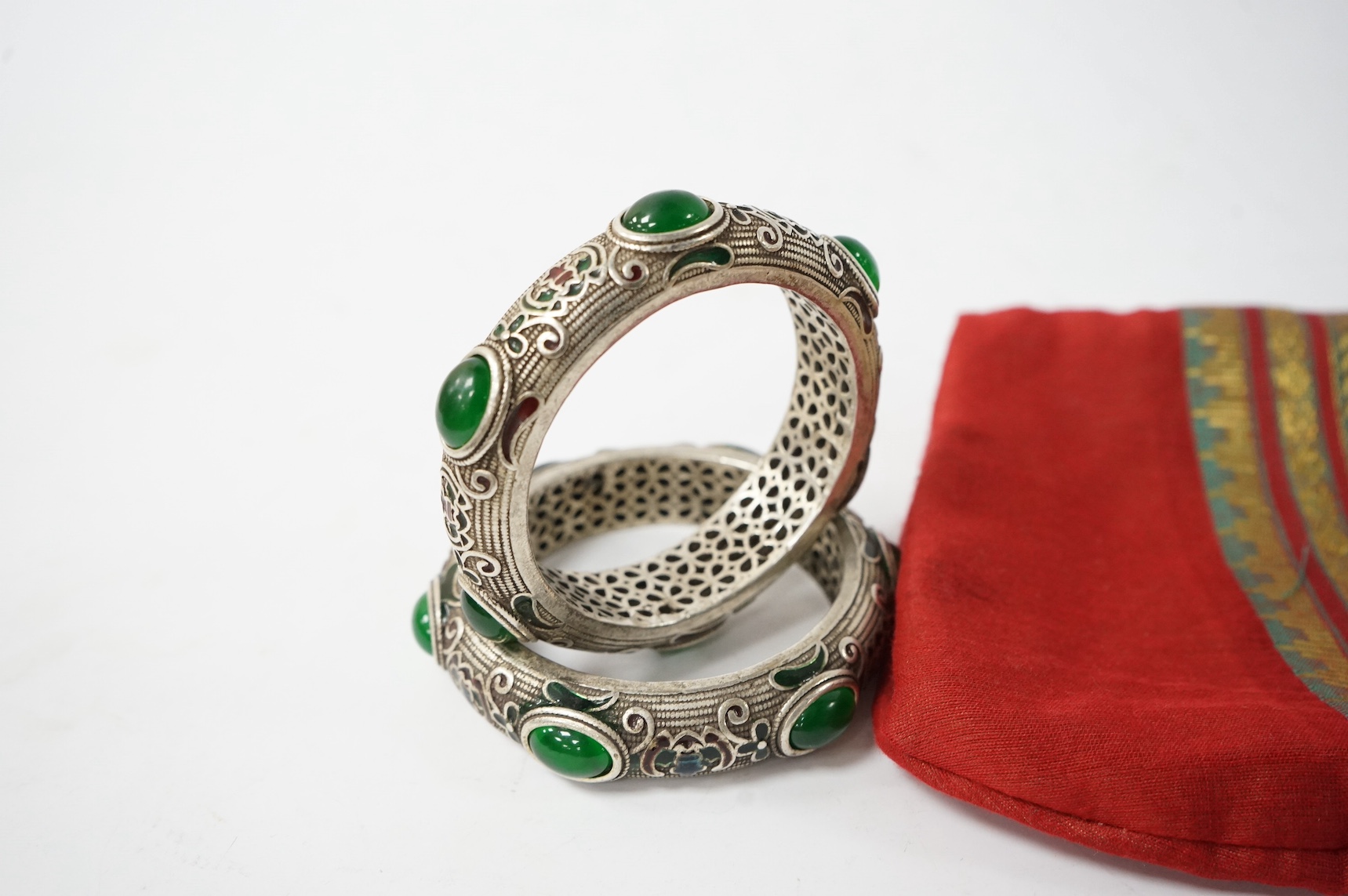 A pair of Mongolian metal and enamel bangles, 8.5cm diameter. Condition - good